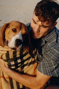 Model wearing Relaxed Fit Check Cotton Shirt in Pewter holding a dog in a Burberry Check towel