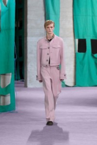 Model wearing Cotton blend jacket in dawn, with polo shirt in black and Cotton blend tailored trousers in dawn.